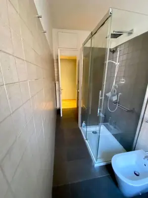 a bathroom with a glass shower and a toilet at Lovely Apartment near metro A Re di Roma in Rome
