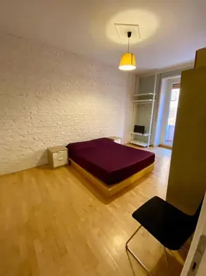 a bedroom with a purple bed in a room at Lovely Apartment near metro A Re di Roma in Rome