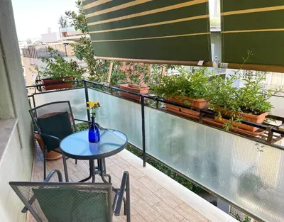 a balcony with a table and chairs and plants at La Magnolia Monteverde Apartment in Rome