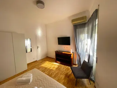 a small living room with a television and a chair at La Magnolia Monteverde Apartment in Rome