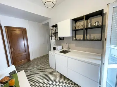 a small room with a bed and wooden shelves at La Magnolia Monteverde Apartment in Rome
