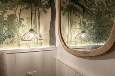 a mirror on a wall with lights in a room at Primo Piano Suites Garden in Rome