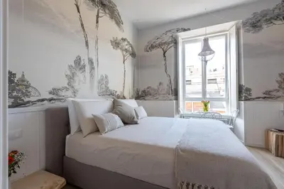 a bedroom with a large bed with a window at Primo Piano Suites Garden in Rome