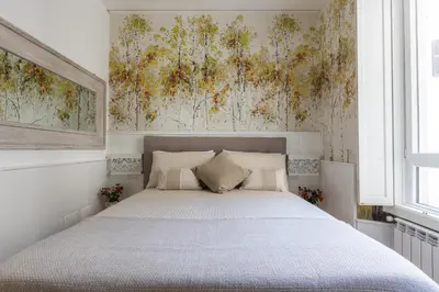 a bedroom with a large bed with white sheets at Primo Piano Suites Garden in Rome