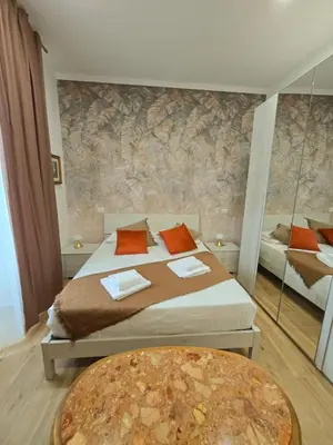a bedroom with a large bed and a table at Linetta Charme House in Rome