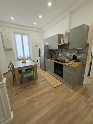 a kitchen with a table and a dining room at Linetta Charme House in Rome