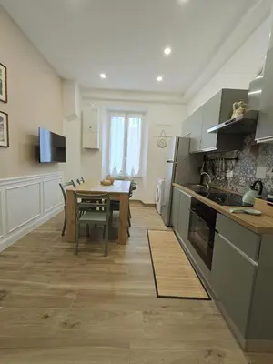 a kitchen with a table and a dining room at Linetta Charme House in Rome