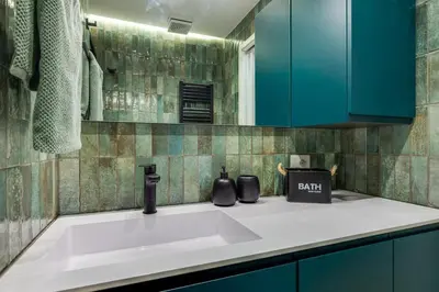 a kitchen counter with a sink and blue cabinets at Casa Anacapri in Rome