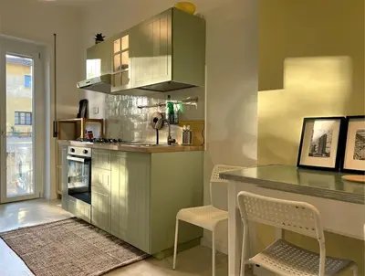 a kitchen with a counter and a table with chairs at Peter House in Rome