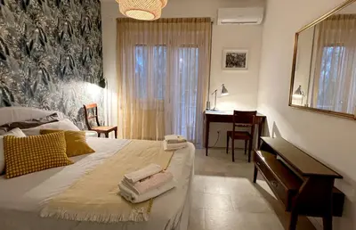 a bedroom with a bed and a desk and a desk at Peter House in Rome
