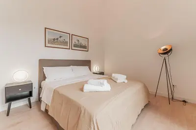 a bedroom with a bed with two towels on it at Casa Martini - Vatican City and Metro Ottaviano in Rome