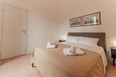 a bedroom with a large bed with towels on it at Casa Martini - Vatican City and Metro Ottaviano in Rome