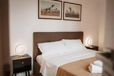 a bedroom with a bed with two night stands and two lamps at Casa Martini - Vatican City and Metro Ottaviano in Rome