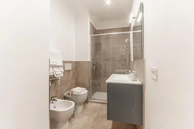 a bathroom with a toilet and a sink and a shower at Casa Martini - Vatican City and Metro Ottaviano in Rome