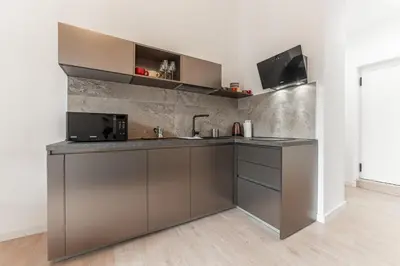 a kitchen with a sink and a microwave at Casa Martini - Vatican City and Metro Ottaviano in Rome