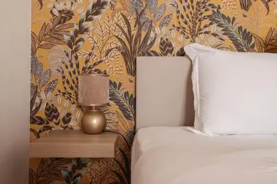 a bedroom with a bed and a lamp on a night stand at Appartamento in via Plauto in Rome