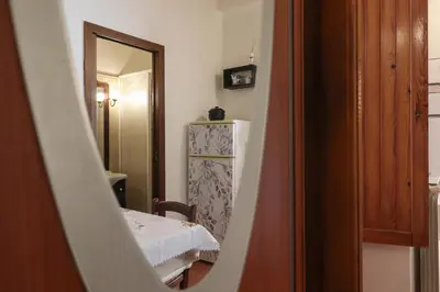 a small room with a table and a refrigerator at Appartamento in via Plauto in Rome