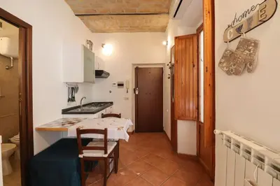 a small kitchen with a table and a stove at Appartamento in via Plauto in Rome