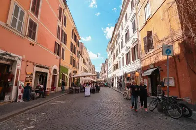 a group of people walking down a street with buildings at Appartamento in via Plauto in Rome