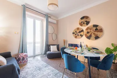 a kitchen with white cabinets and a counter top at Apartment in Tuscolana Train Station & Metro A in Rome