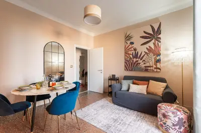 a living room with a table and a couch at Apartment in Tuscolana Train Station & Metro A in Rome