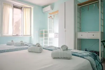a room with three beds with towels on them at Roma centro Vicino al Vaticano - Free WiFi in Rome