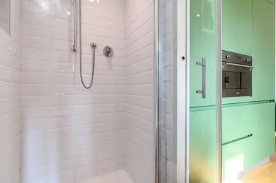 a bathroom with a shower with a glass door at Casa Sardi in Rome