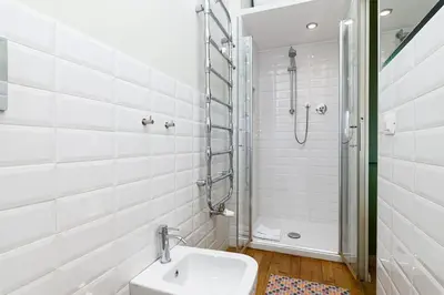 a white bathroom with a sink and a shower at Casa Sardi in Rome