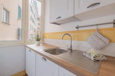 a kitchen with a sink and a window at Apartment In Via Merulana Central Rome by Halldis in Rome
