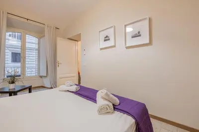 a bedroom with a bed with towels on it at Apartment In Via Merulana Central Rome by Halldis in Rome