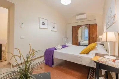 a bedroom with a bed and a table and a mirror at Apartment In Via Merulana Central Rome by Halldis in Rome
