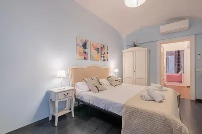 a bedroom with two beds and a table and a window at Apartment In Via Merulana Central Rome by Halldis in Rome