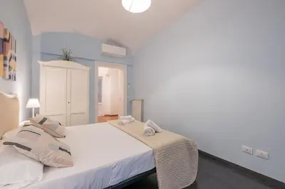 a bedroom with a white bed with towels on it at Apartment In Via Merulana Central Rome by Halldis in Rome