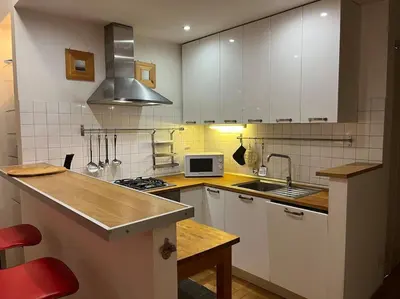 a kitchen with white cabinets and a sink and a microwave at My Home in Rome in Rome