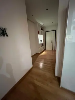 an empty room with white walls and a wooden floor at My Home in Rome in Rome