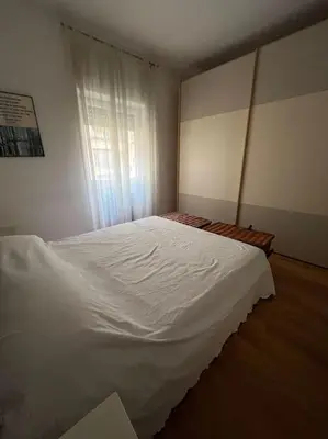 a bedroom with a white bed and a window at My Home in Rome in Rome