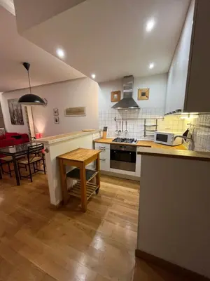 a large kitchen with a table and a counter top at My Home in Rome in Rome