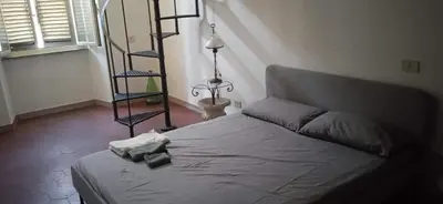 a bedroom with a bed and a spiral staircase at InsideRome Appartamento Vaticano e Centro Storico in Rome