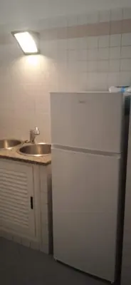 a kitchen with a white refrigerator and a sink at InsideRome Appartamento Vaticano e Centro Storico in Rome