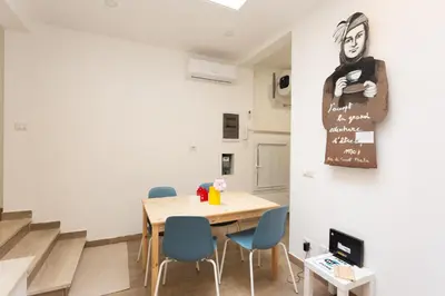 a dining room with a wooden table and blue chairs at Da Cesare e Chloe al Colosseo in Rome