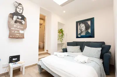 a bedroom with a bed and a painting on the wall at Da Cesare e Chloe al Colosseo in Rome