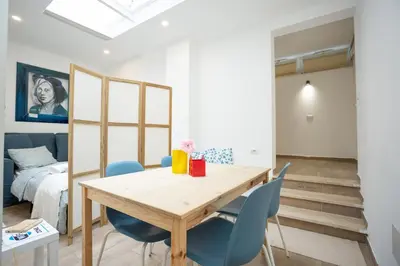 a dining room with a wooden table and blue chairs at Da Cesare e Chloe al Colosseo in Rome