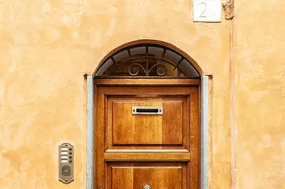 a wooden door with an arch above it at farnese jacuzzi apartment in Rome