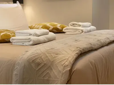 a group of towels sitting on top of a bed at THE BREAK - Campo Marzio Studio in Rome