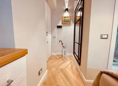 a hallway with white walls and a wooden floor at THE BREAK - Campo Marzio Studio in Rome