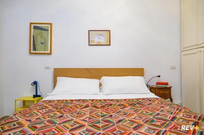 a bedroom with a bed with a colorful bedspread at Art Apartment Rome City Center in Rome