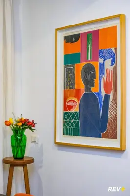 a painting on a wall with a vase of flowers at Art Apartment Rome City Center in Rome