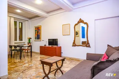 a living room with a couch and a mirror at Art Apartment Rome City Center in Rome