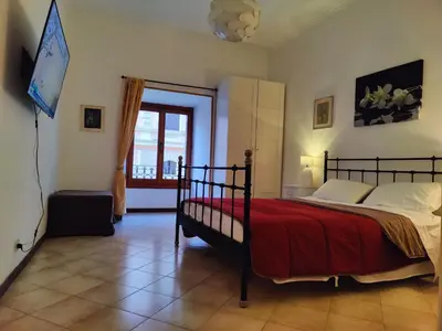 a bedroom with a bed with a red blanket at Appartamento Gracchi 15 in Rome