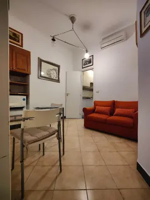 a living room with a red couch and a table at Appartamento Gracchi 15 in Rome